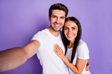 Self-portrait of his he her she nice attractive charming lovely sweet cheerful cheery glad couple spending time vacation holiday hugging isolated on purple violet lilac color pastel background