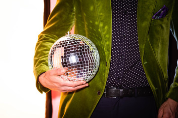 cropped view of man holding shiny disco ball on white