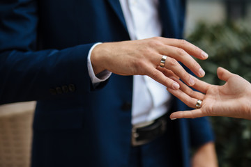 Happy to be in love. Close up of loving couple holding hands  with wedding rings