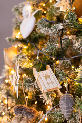 Closeup of garland, balls and tiny toys hanging on Christmass tree