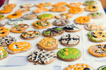 Assorted Hallowen cookies on yellow background. Halloween holiday sugar biscuits including pumpkin,...