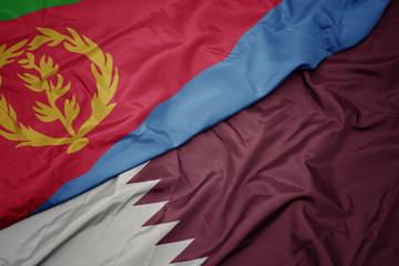 waving colorful flag of qatar and national flag of eritrea.