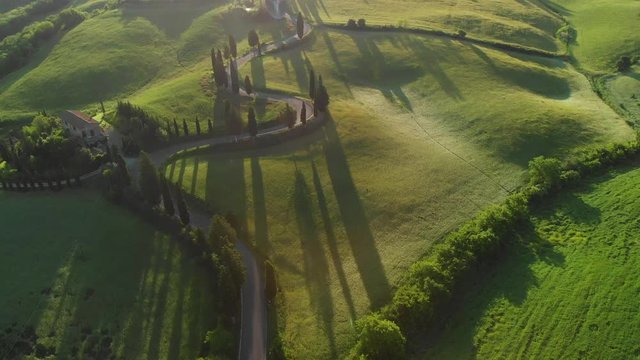 Aerial flyover the beautiful sunset landscape in Tuscany, Italy.