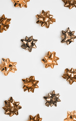 Golden christmas bows on white background.