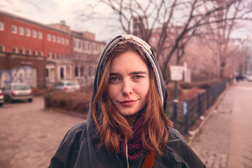 portrait of a young woman with hoodie in the streets of Berlin