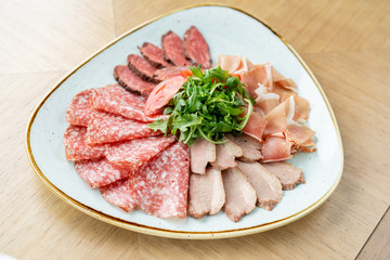 Meat plate, delicacy and Anantipasto. Salami, roast beef, Parma ham, smoked duck breast. Restaurant menu.