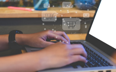 Woman hand using laptop with cart icon concept shopping online.