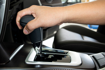 Obraz na płótnie Canvas Hand grab on automatic gear shift in car.