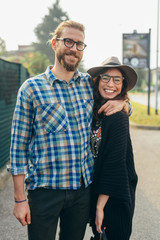 Fototapeta premium Young beautiful happy couple outdoor posing hugging