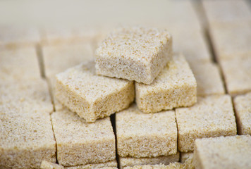 Sugar cubes on table background - Close up of brown sugar stacked in box