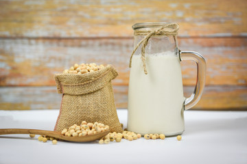 Soybean and dried soy beans on white bowl - Soy milk in glass jar for healthy diet drink and...