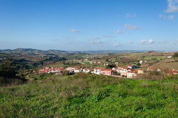 Fototapeta na wymiar Beautiful view of the fields and city in Portugal, panorama. Sky with clouds. Place for text.