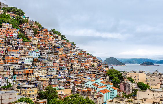 Brazilian favelas on the hill with city downtown below at the tropical bay, Rio De Janeiro, Brazil
