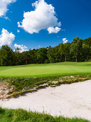 Golf Course with beautiful putting green. Golf course with a rich green turf beautiful scenery.