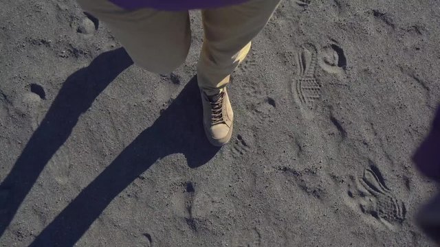 Man waks through so called "sea of sand" at the Bromo volcano inside the Tengger caldera on the Java Island, Indonesia