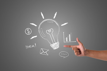 Hand pointing to the business concept written with white chalk, draw concept.