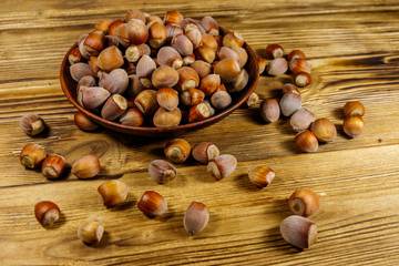 Hazelnuts in ceramic plate on a wooden table