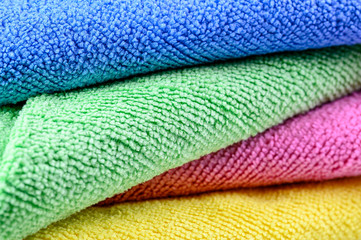 colorful microfiber towels for beach use and domestic cleaning stacked in a pile