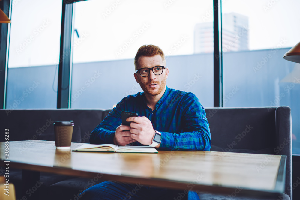 Aufkleber pondering hipster guy in spectacles thoughtful looking away while waiting for call from customer ser