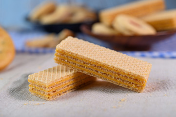 Many cookies are placed on the fabric and then placed on a wooden table.