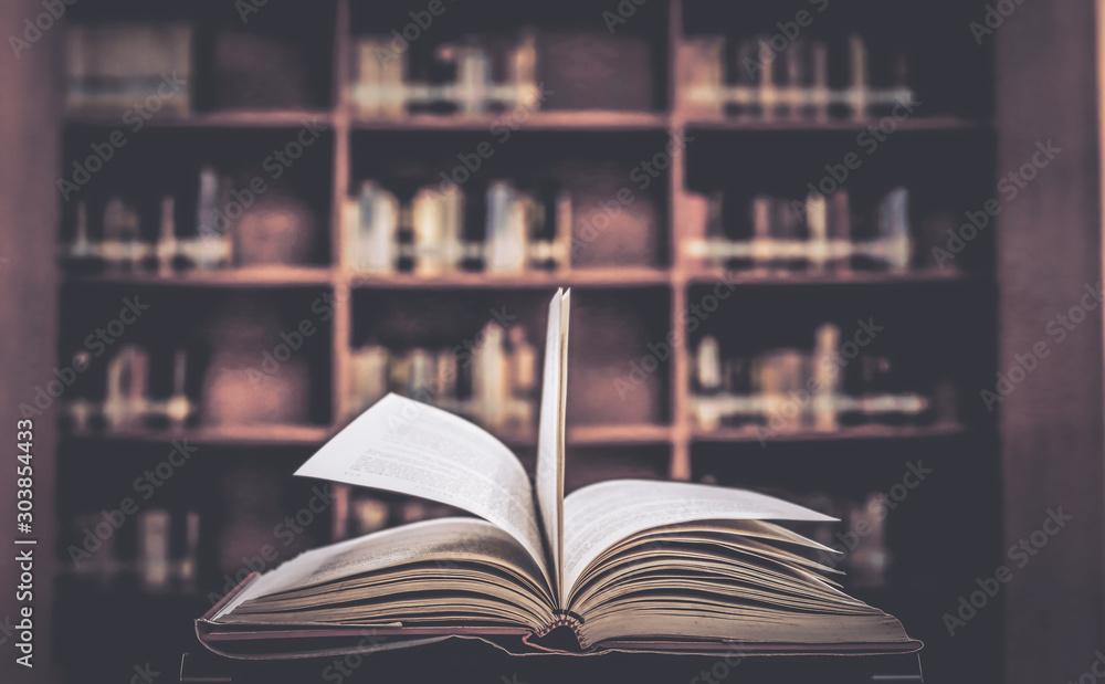 Aufkleber stack of books in the library and blur background