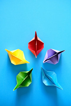 Authentic Origami Boats In Circle On Blue Background