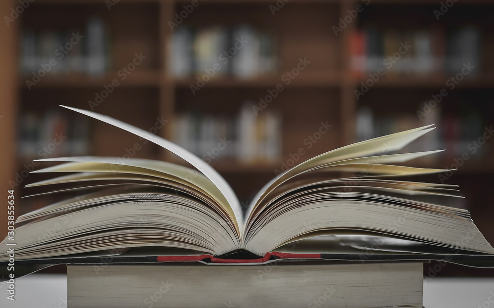 Poster stack of books in the library and blur bookshelf background
