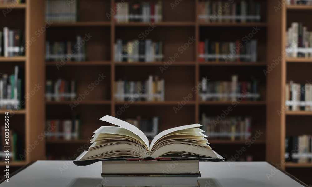 Poster stack of books in the library and blur bookshelf background