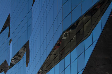 Obraz premium High tech glass facade in the financial district. Contemporary architecture, passive energy, nanotech windows. Natural daylight, corporate concept. Wall Street, New York.