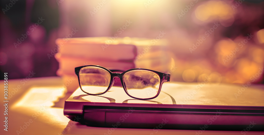 Aufkleber stack of books with glasses placed on the open book in library.