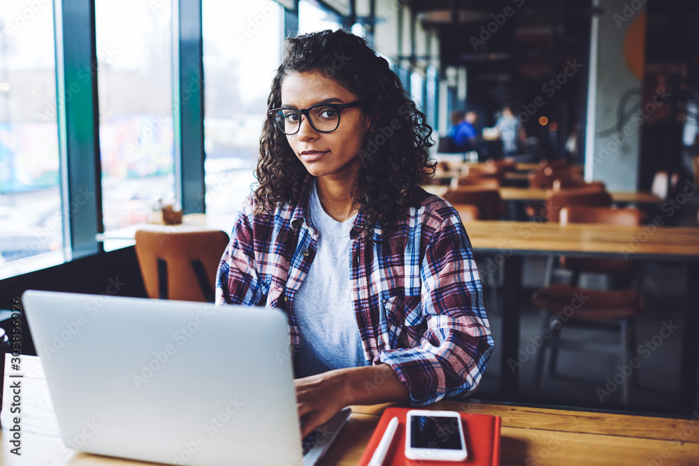 Poster portrait of attractive black woman in eyewear using 4g internet connection for communicate with foll