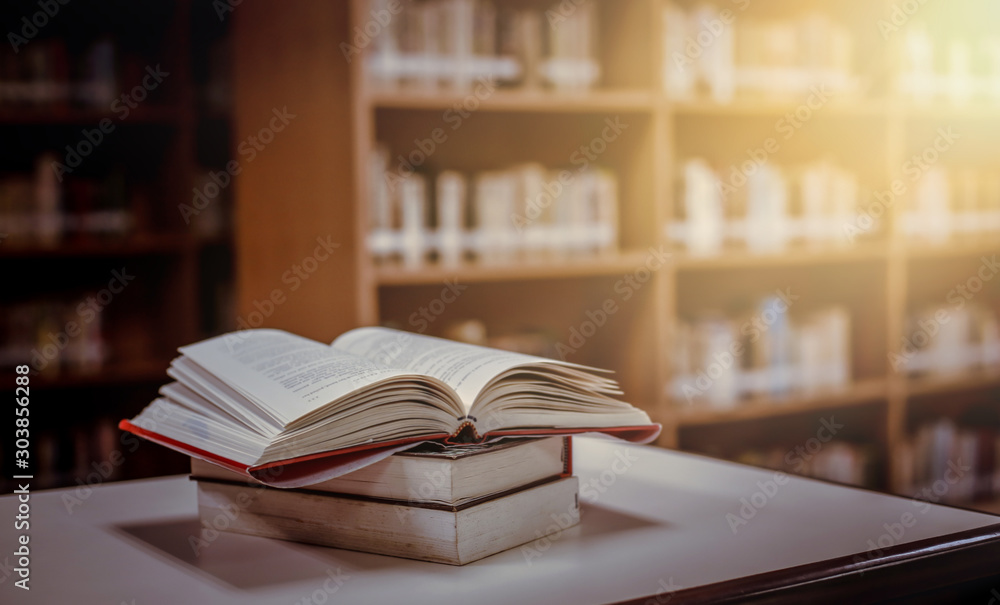 Poster stack of books in the library and blur bookshelf background