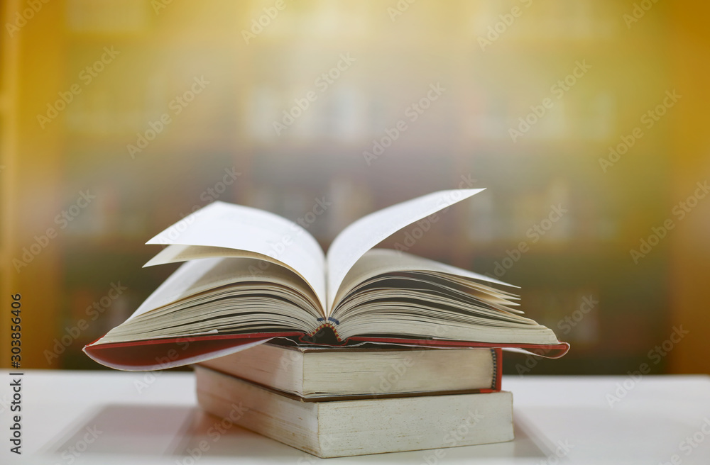 Poster stack of books in the library and blur bookshelf background