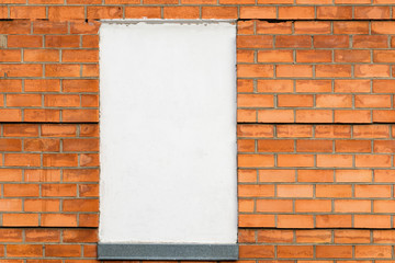carrot color brick wall - empty white poster, copy space.