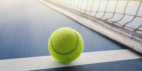 Close-up shots of tennis balls in tennis courts With a mesh as a blurred background And the light shining on the ground makes the image beautiful - Powered by Adobe