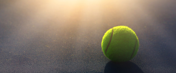 Close-up shots of tennis balls in tennis courts With a mesh as a blurred background And the light...
