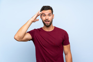 Handsome man over isolated blue background has just realized something and has intending the solution