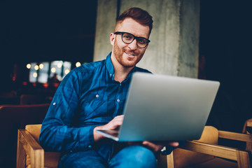 Portrait of young caucasian man with laptop
