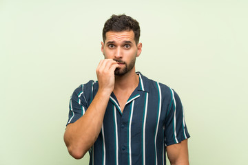 Handsome man over isolated background nervous and scared