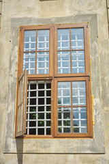 Wooden modern window frames in an old house, open window