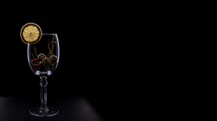 Bright wine glass silhouette isolated on a dark leather background. Christmas and New year design.  Dark mode.  The photo for  banners and posters. Concept of sales, Christmas presents and shopping.