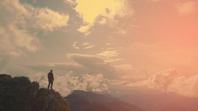 The man standing against the beautiful mountain landscape