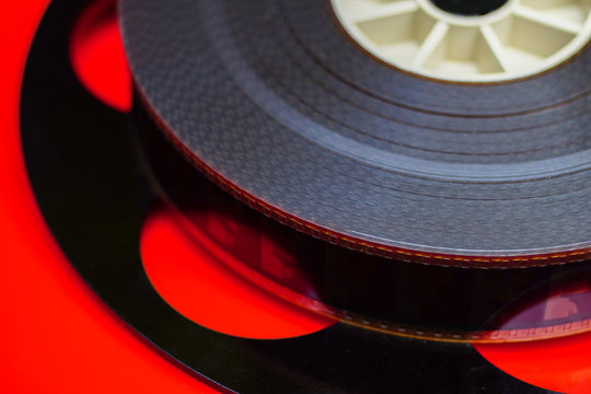 35mm Film On A Black Spinning Wheel And A Red Background