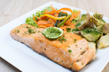  steak fried salmon, steamed potatoes and vegetables