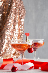 Glasses with pink champagne in festive environment