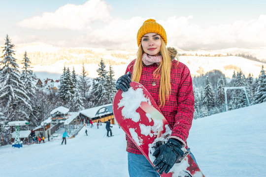 beautiful girl snowboarder smile alone with snowboard, winter sport ski outside snow, yellow hat, active lifestyle