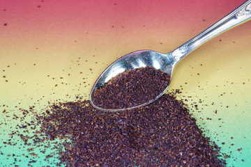 Sumac spice with macro lens photographed against colorful gradient in studio
