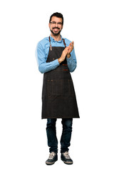 Full-length shot of Man with apron applauding after presentation in a conference over isolated...