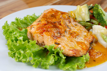 Salmon fillet in citrus sauce, fried plantain and vegetables