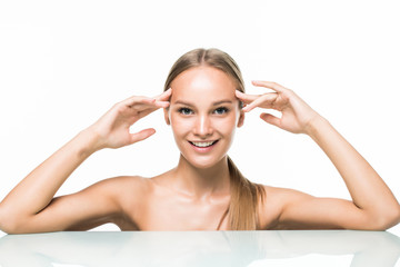 Beautiful woman applying cosmetic cream treatment on her face on white background